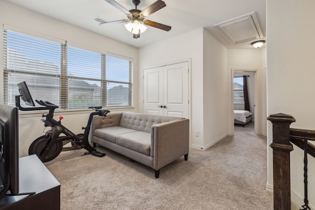 carpeted living room featuring ceiling fan