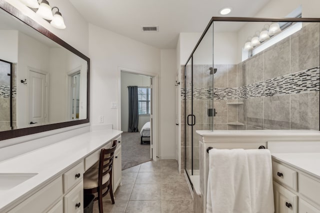 bathroom with vanity, tile patterned flooring, and a shower with door