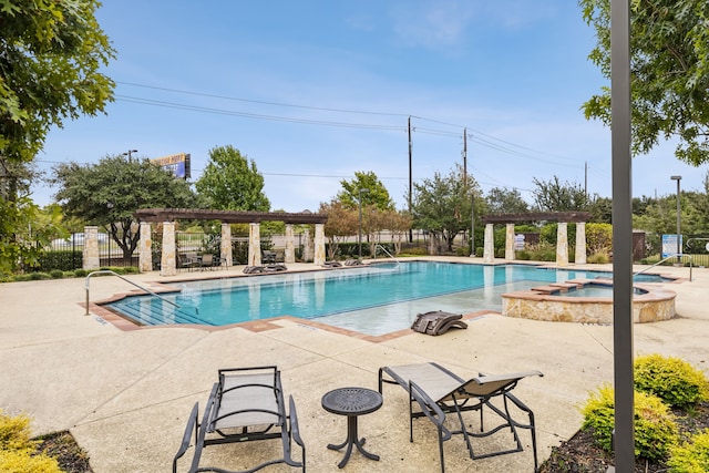 view of swimming pool with a hot tub, a pergola, and a patio