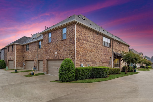 property exterior at dusk with a garage