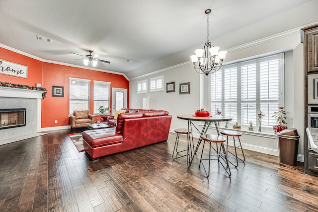 dining room featuring vaulted ceiling, dark hardwood / wood-style flooring, a premium fireplace, and crown molding