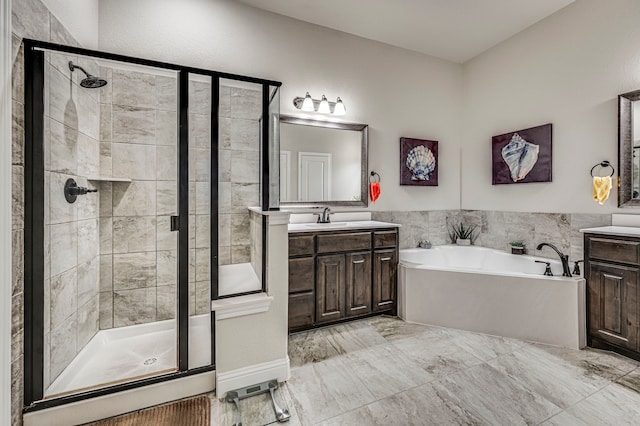 bathroom with vanity and independent shower and bath