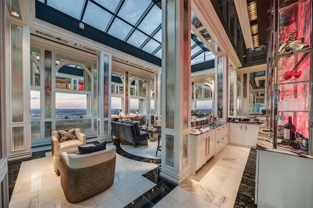 interior space with white cabinetry and a high ceiling