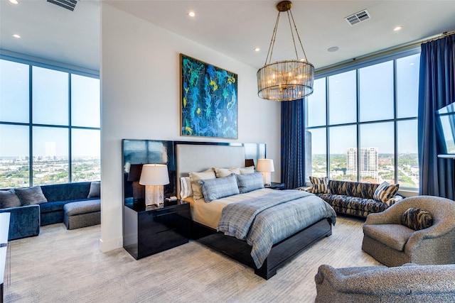 carpeted bedroom with floor to ceiling windows and a notable chandelier