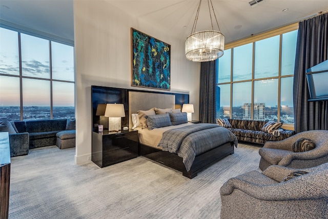 bedroom featuring a notable chandelier, expansive windows, carpet, and multiple windows