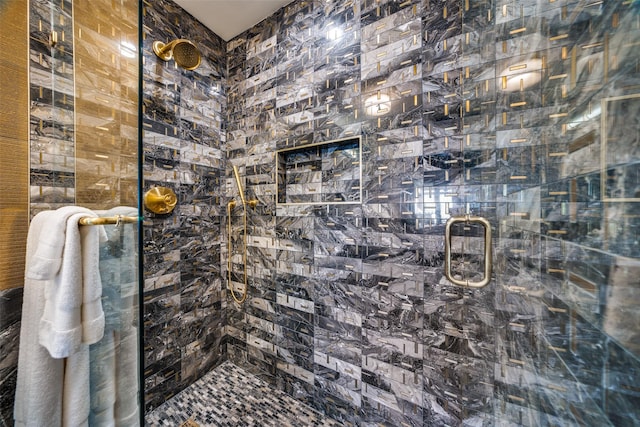 bathroom featuring a shower with door