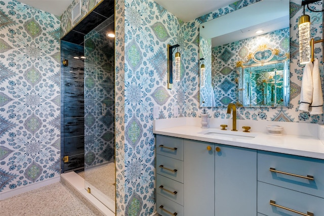 bathroom featuring tiled shower and vanity