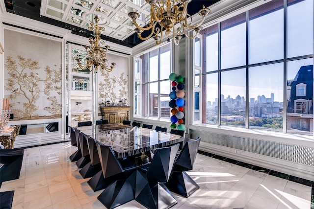 kitchen featuring dark stone counters, a chandelier, light tile patterned flooring, a breakfast bar, and crown molding