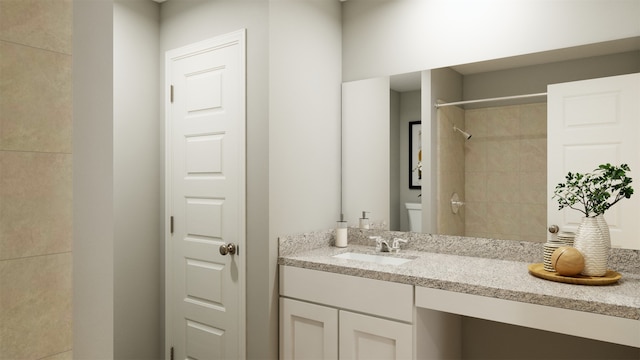 bathroom featuring a tile shower and vanity