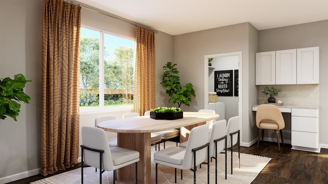 dining space featuring dark hardwood / wood-style flooring and built in desk