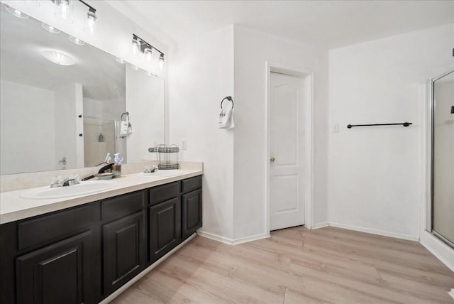 bathroom featuring vanity, a shower with shower door, and hardwood / wood-style floors