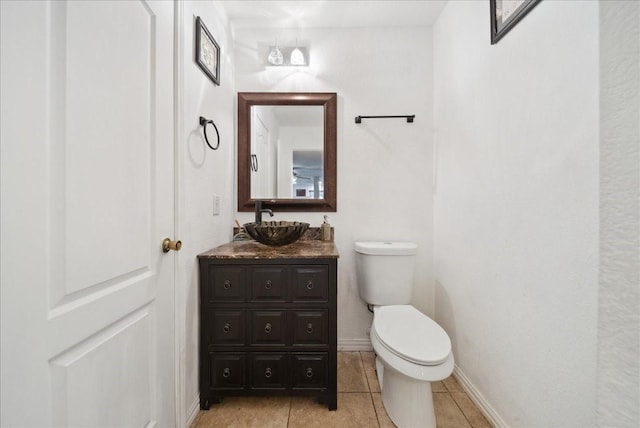 bathroom with vanity, tile patterned floors, and toilet