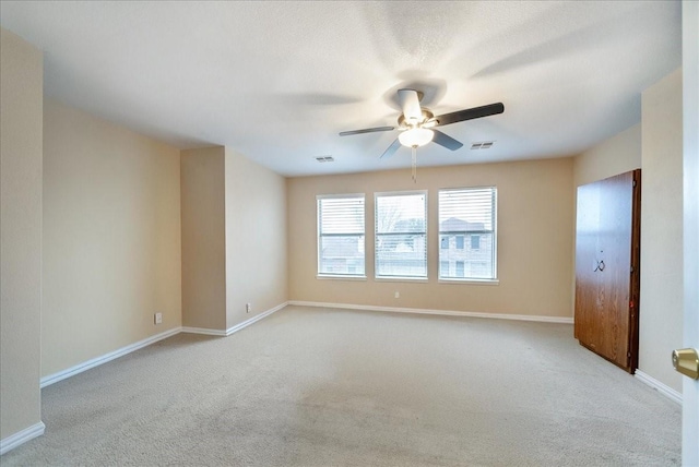 empty room with light carpet and ceiling fan