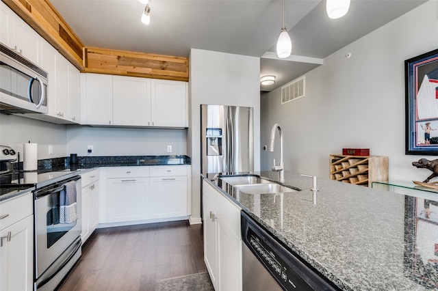 kitchen featuring sink, white cabinets, appliances with stainless steel finishes, and dark stone countertops