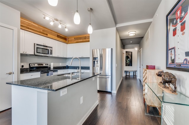 kitchen with pendant lighting, sink, an island with sink, stainless steel appliances, and white cabinets