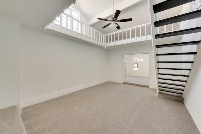 interior space with ceiling fan with notable chandelier, light carpet, and a towering ceiling