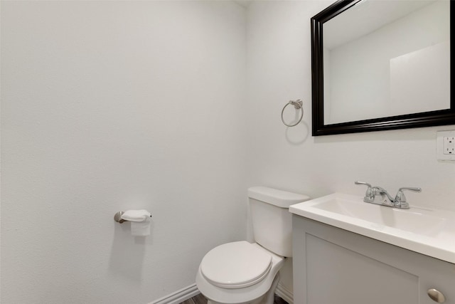 bathroom featuring toilet and vanity