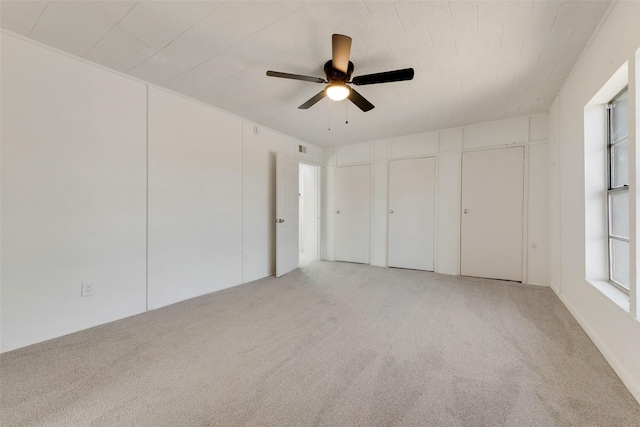 unfurnished bedroom featuring ceiling fan and light colored carpet