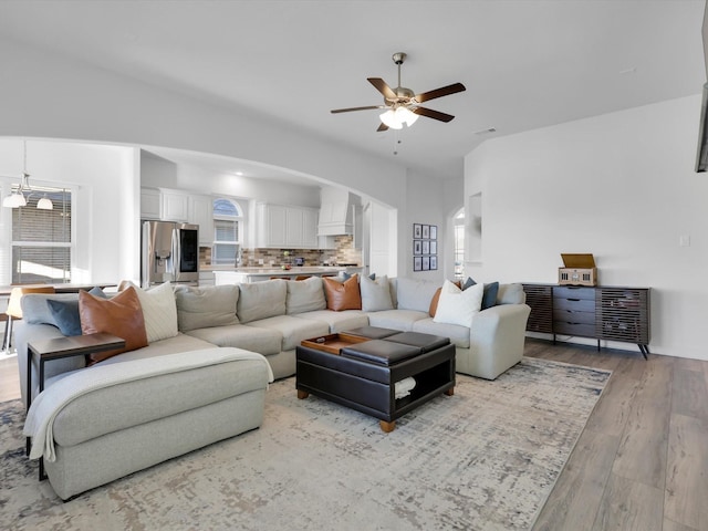 living room with light hardwood / wood-style floors and ceiling fan