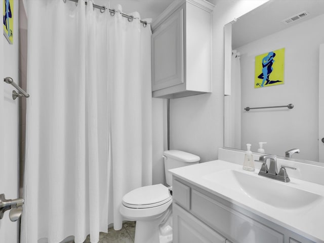 bathroom featuring toilet and vanity