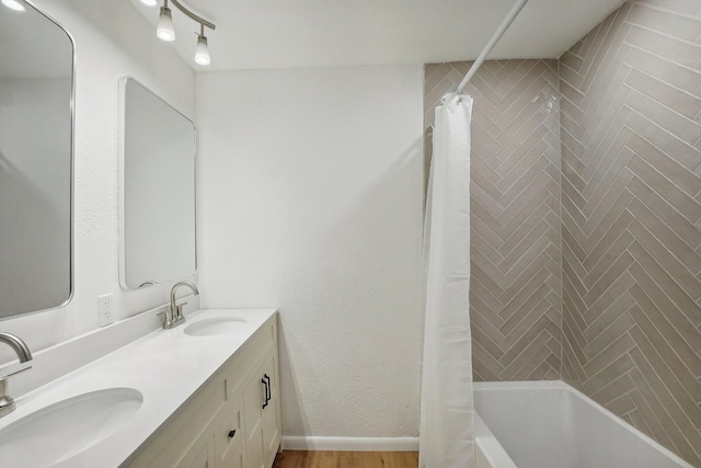 bathroom featuring vanity and shower / bathtub combination with curtain