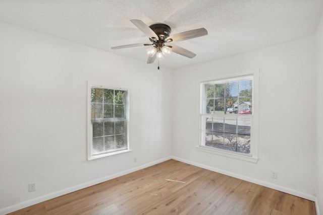 unfurnished room with ceiling fan, a healthy amount of sunlight, and light hardwood / wood-style floors