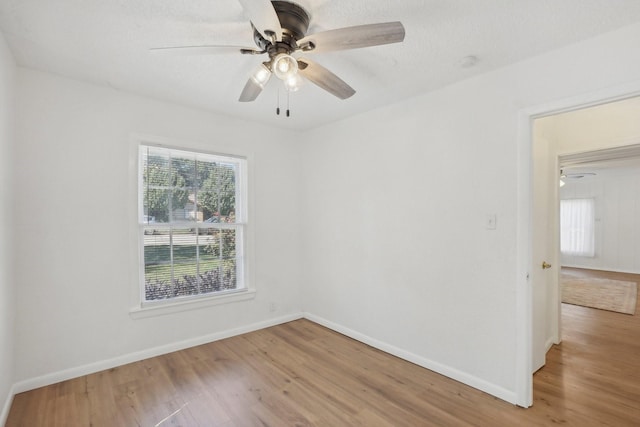 unfurnished room featuring ceiling fan and hardwood / wood-style floors