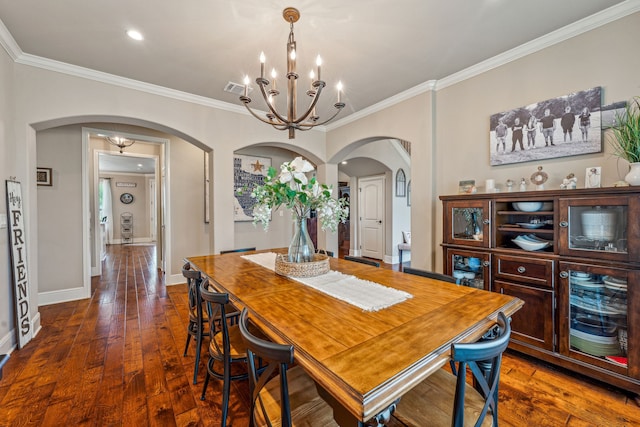 dining area featuring a chandelier, ornamental molding, and dark hardwood / wood-style flooring