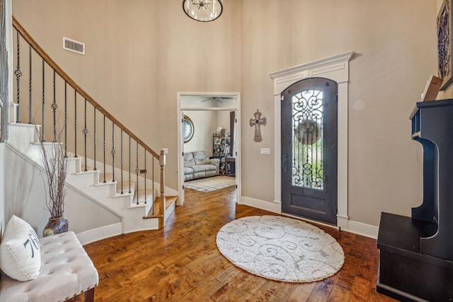 entryway featuring a high ceiling and dark hardwood / wood-style flooring