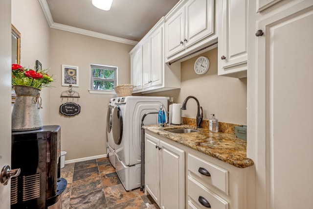 laundry area featuring crown molding, sink, separate washer and dryer, and cabinets