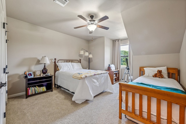 bedroom with ceiling fan, light carpet, and vaulted ceiling