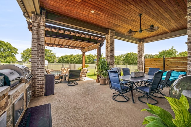 view of patio featuring ceiling fan, an outdoor kitchen, and area for grilling