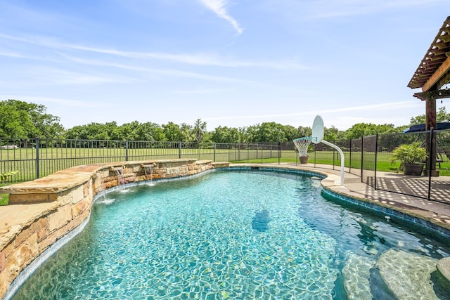 view of pool with pool water feature and a yard