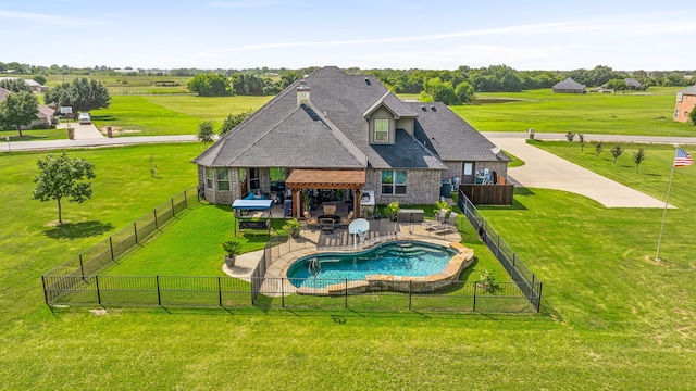 view of pool featuring a lawn, an outdoor fireplace, and a patio