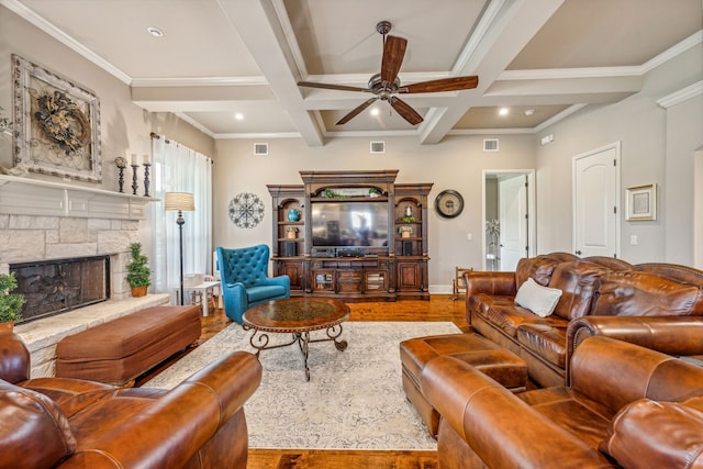 living room with coffered ceiling, a fireplace, wood-type flooring, ornamental molding, and beam ceiling