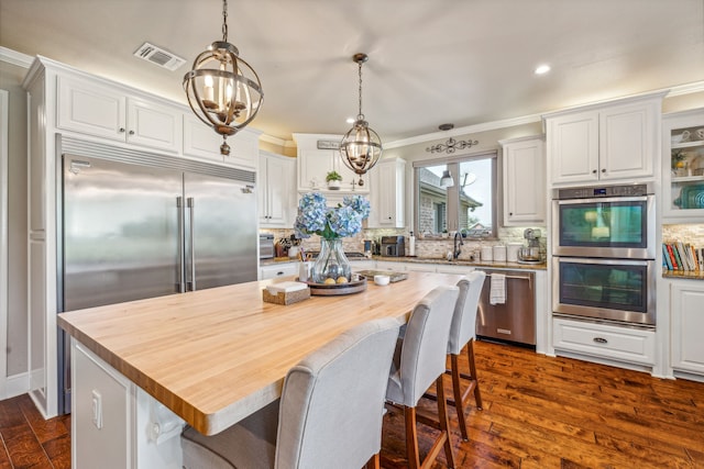 kitchen with white cabinets, appliances with stainless steel finishes, and a center island