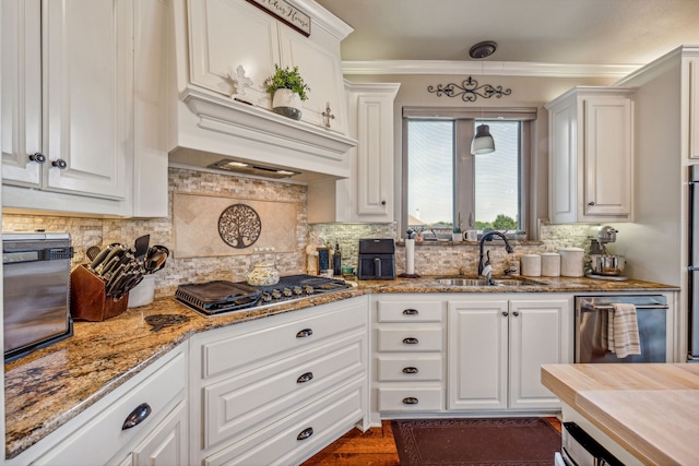 kitchen featuring white cabinetry and sink