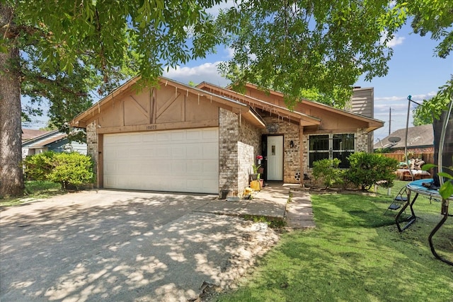 view of front of house with a garage and a front lawn