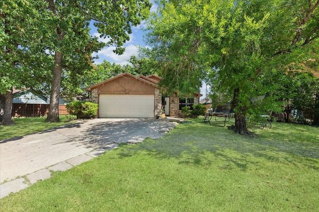 view of front of property with a garage, a front lawn, and a trampoline