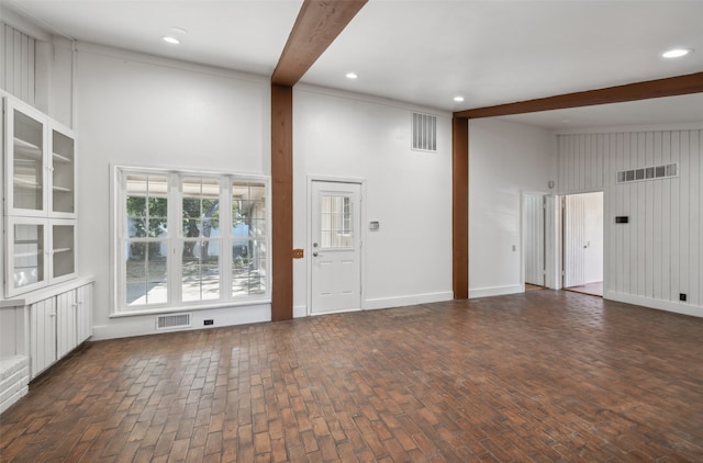 interior space featuring beamed ceiling and a high ceiling