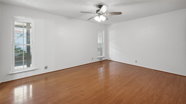 spare room featuring wood-type flooring and ceiling fan