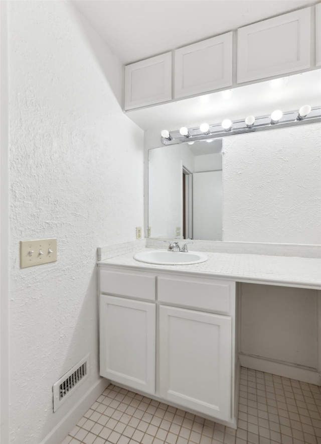 bathroom with vanity and tile patterned floors