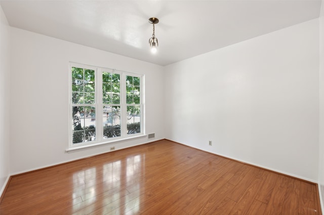 unfurnished room featuring hardwood / wood-style flooring