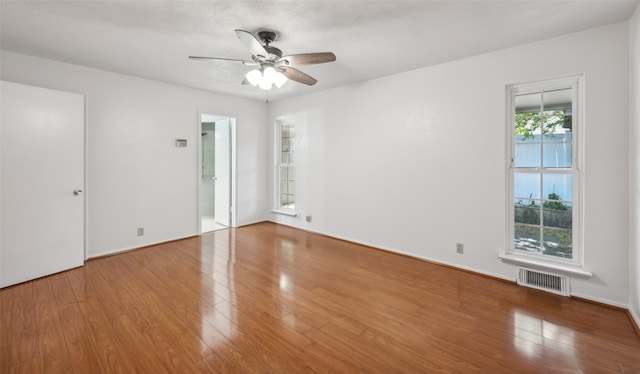 unfurnished room with hardwood / wood-style flooring and ceiling fan