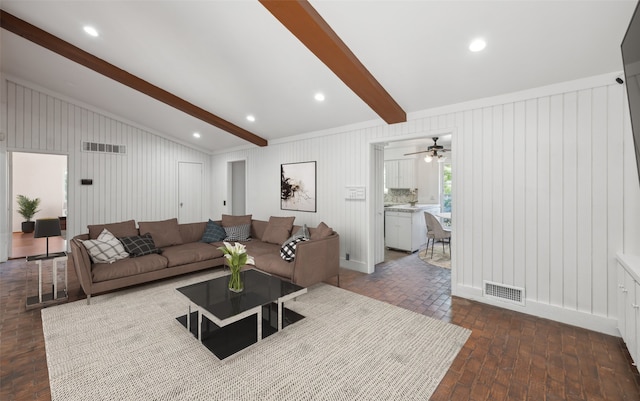 living room with lofted ceiling with beams