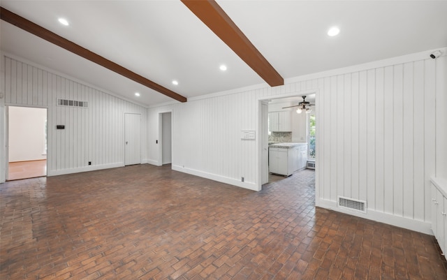 unfurnished living room featuring vaulted ceiling with beams and ceiling fan