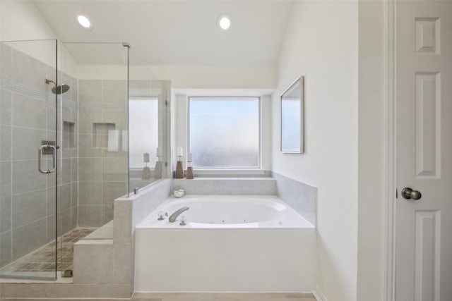 bathroom featuring shower with separate bathtub