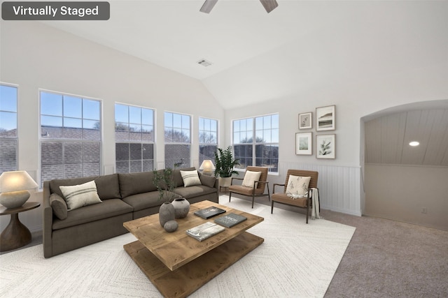 carpeted living room featuring lofted ceiling and ceiling fan