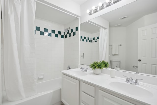 full bathroom featuring vanity, shower / bath combo with shower curtain, and toilet