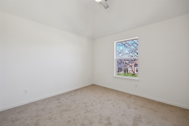 empty room with ceiling fan, light colored carpet, and plenty of natural light